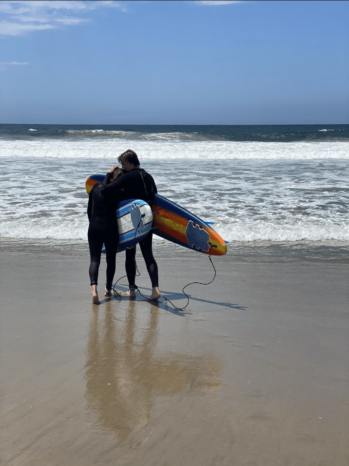 Lexi Silverstein at the beach with a surfboard