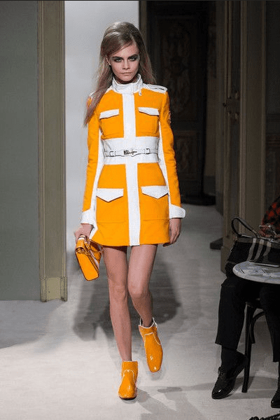 A model shows an outfit on the runway