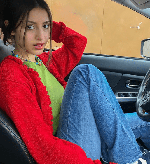 A woman wearing a sage green top