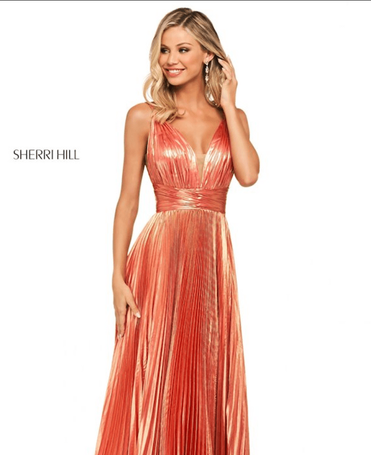 A woman wearing a coral Sherri Hill dress