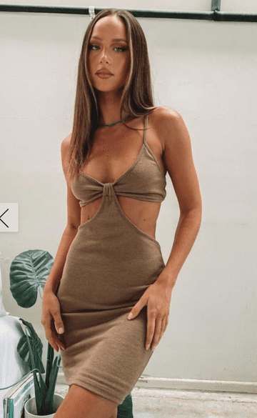 A woman wearing a tan mini dress