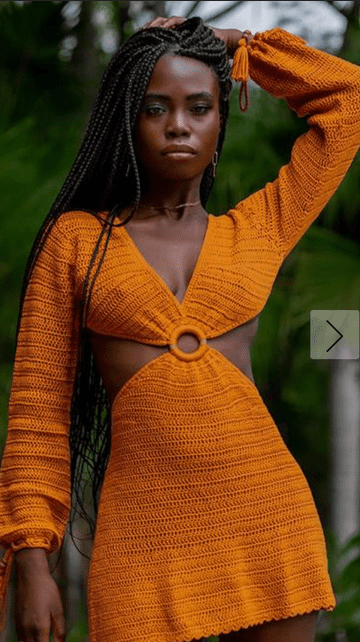 A woman wearing an orange mini dress