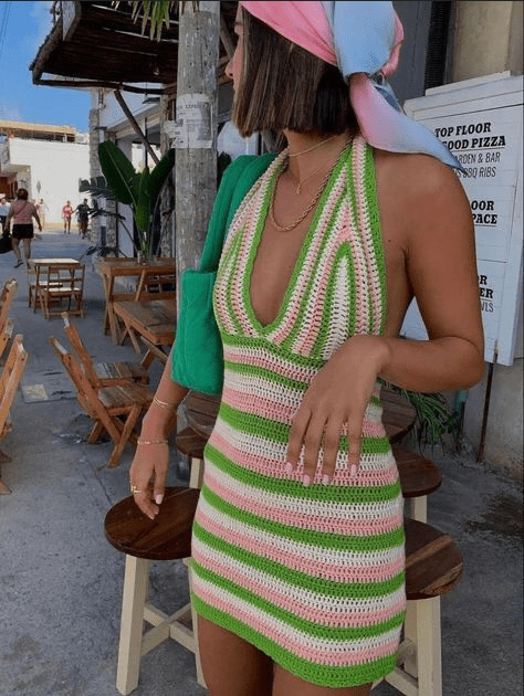 A woman wearing a colorful crochet dress