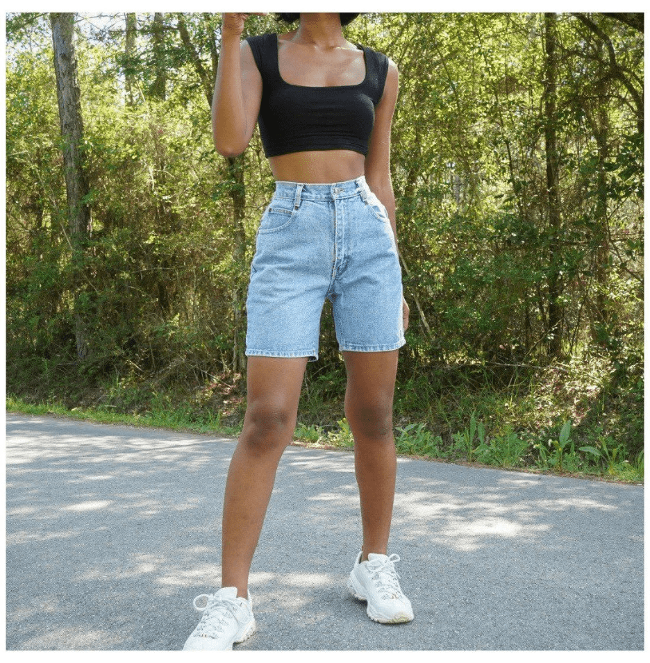 A woman wearing denim mom shorts