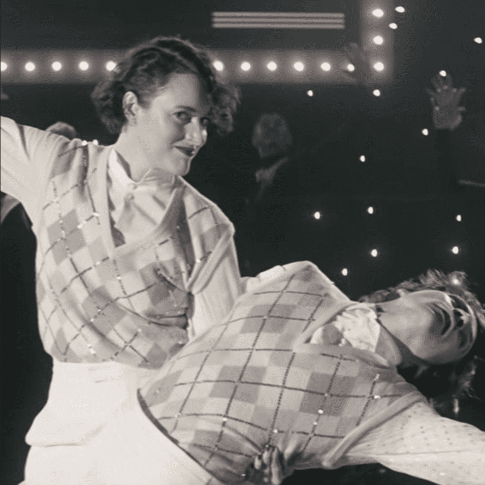 Harry Styles wearing an argyle sweater in a music video