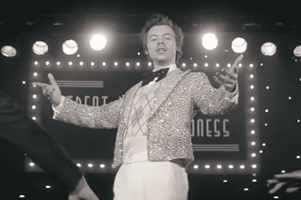 Harry Styles wearing an argyle sweater in a music video