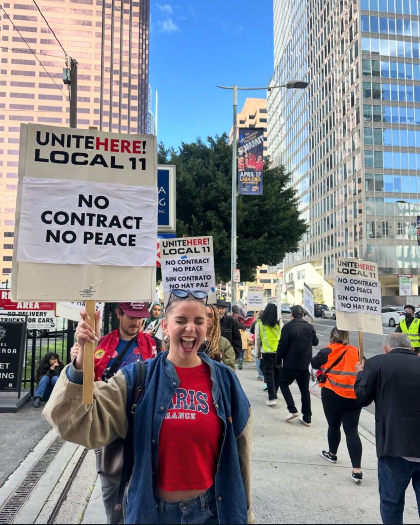 Lexy Silverstein protesting for hotel workers ratifying new contracts
