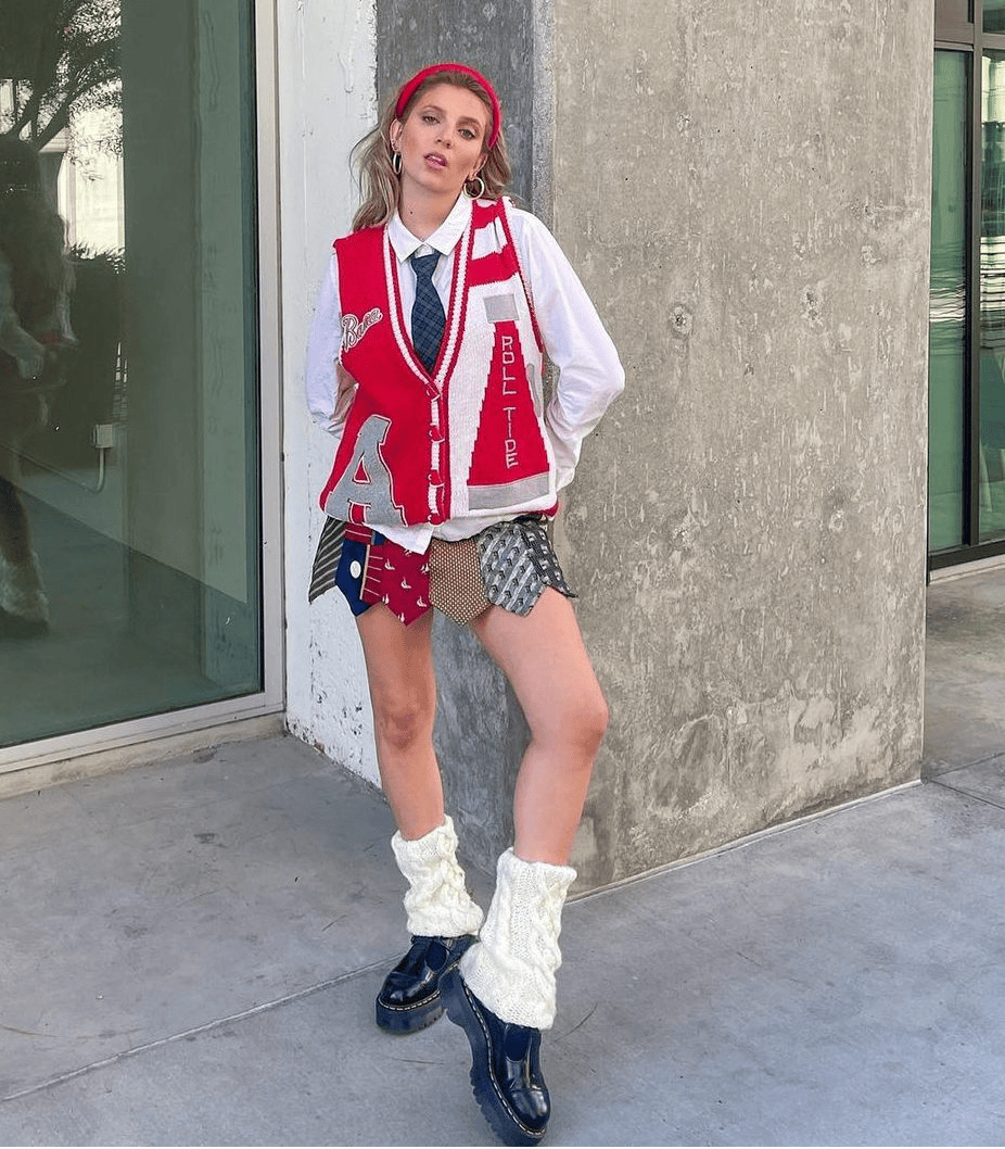 Sustainable fashion advocate Lexy Silverstein wearing a DIY school girl Halloween costume with a white shirt, red vest, tie, patterned skirt and leg warmers.